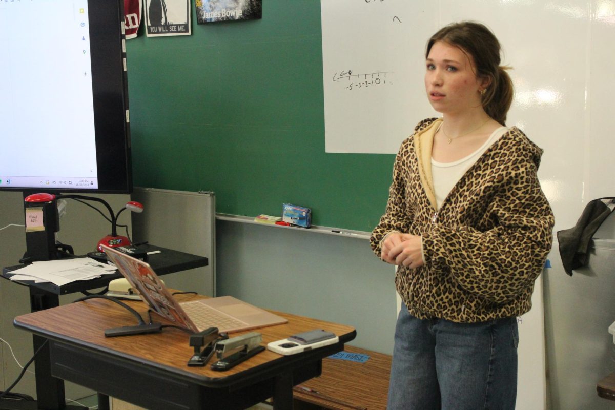 INSTRUCTING STUDENTS: Olivia Baird stands in front of the Gorzycki Middle Schoolers. Baird and Larkin Bock have been mentoring the students on debate, to prepare them for high school. 