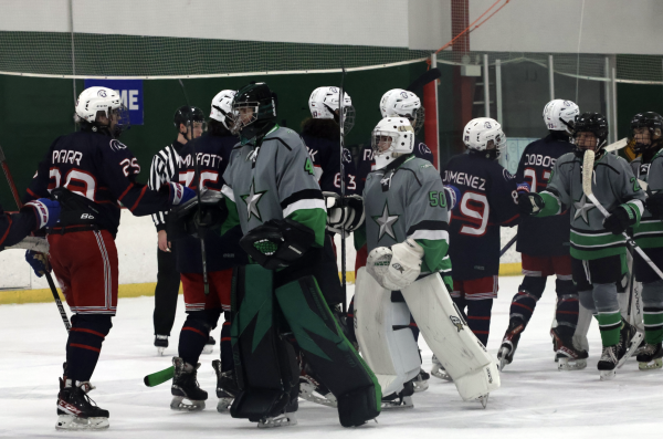 The Texas Jr Stars, wearing grey jerseys, demonstrate sportsmanship as both teams congratulate each other after a well played match. 