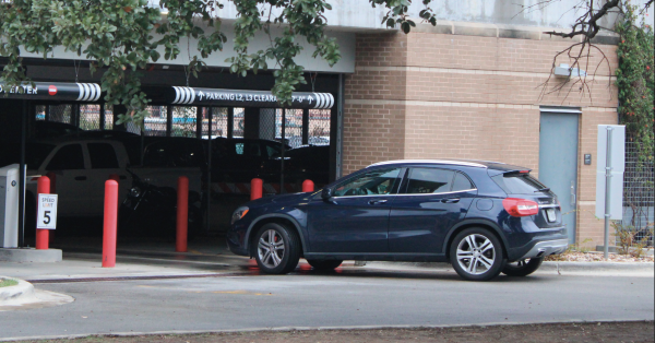 PASSING THROUGH: A student pulls up to the parking garage where their RFID tag needs to be scanned before they're allowed to enter. If the system does not allow the car to enter, the student may have to back up and try to enter again.