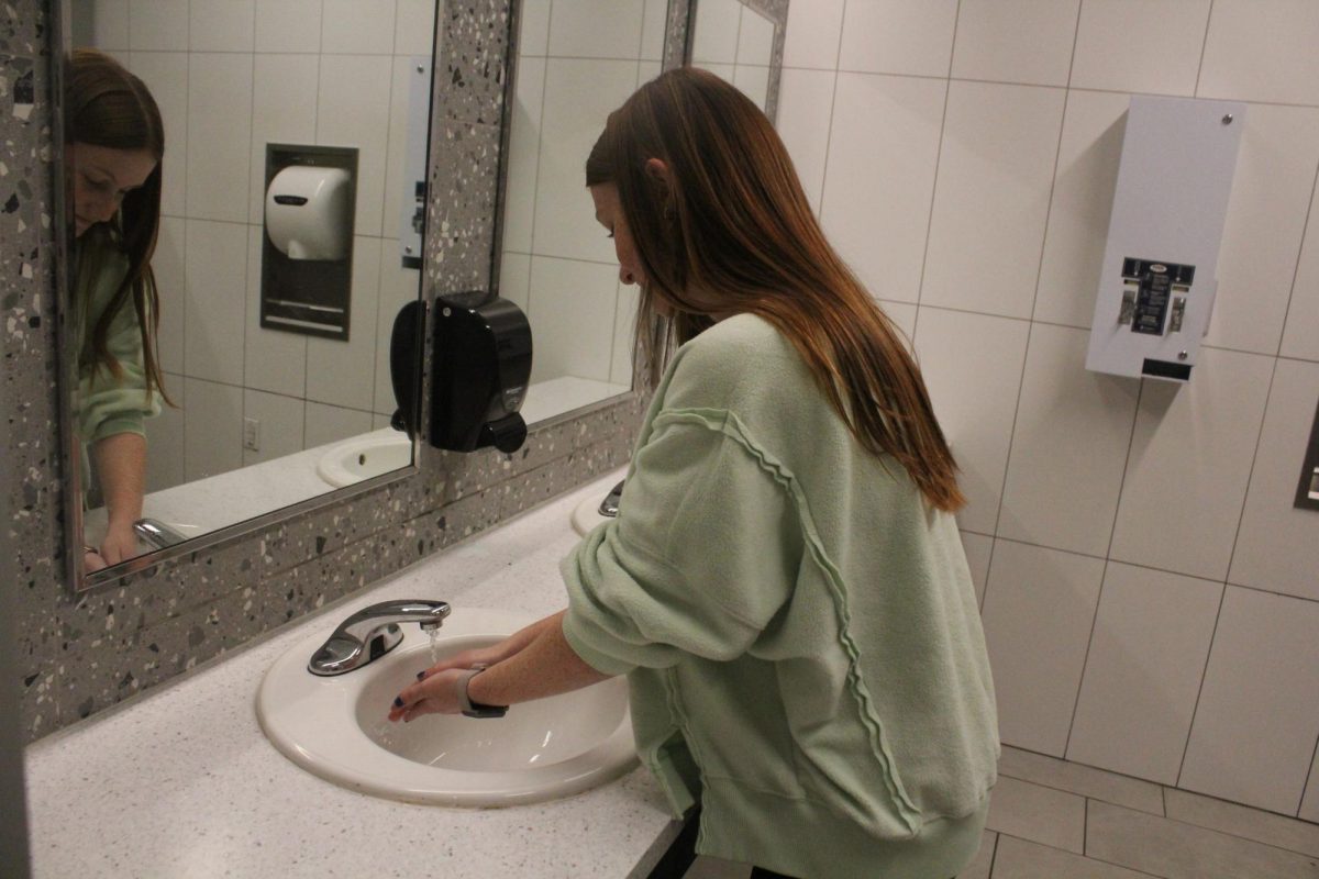 A Bowie student washes her hands after using the new bathrooms in L hall. However, although the bathrooms are new, they still get clogged, crowded, and can be unfunctional. 