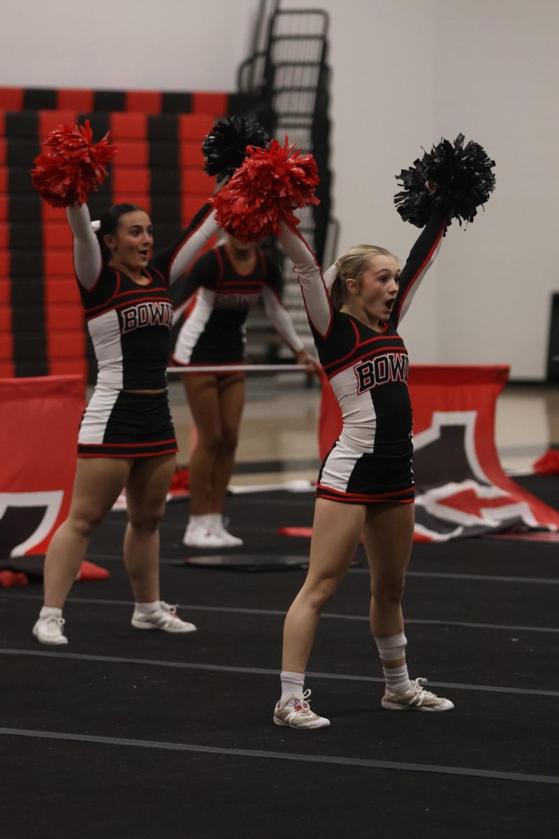 REACHING FOR THE STARS: Sophomore Jocelyn Claire alongside Denisa Williams are hyping up the crowd in preparation for nationals. This gave them the momentum needed to do good in the coming weeks.