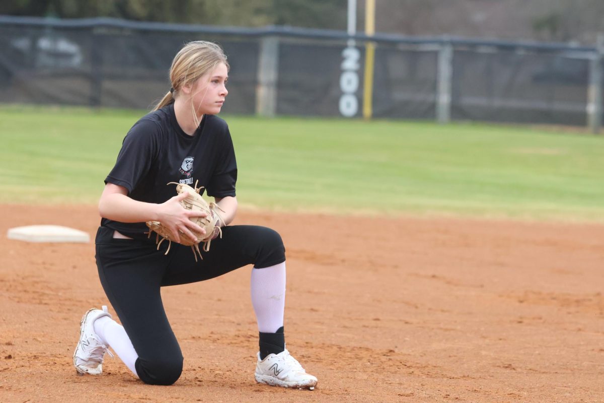 Ellie Lauer kneels down to prepare for incoming ground balls.
