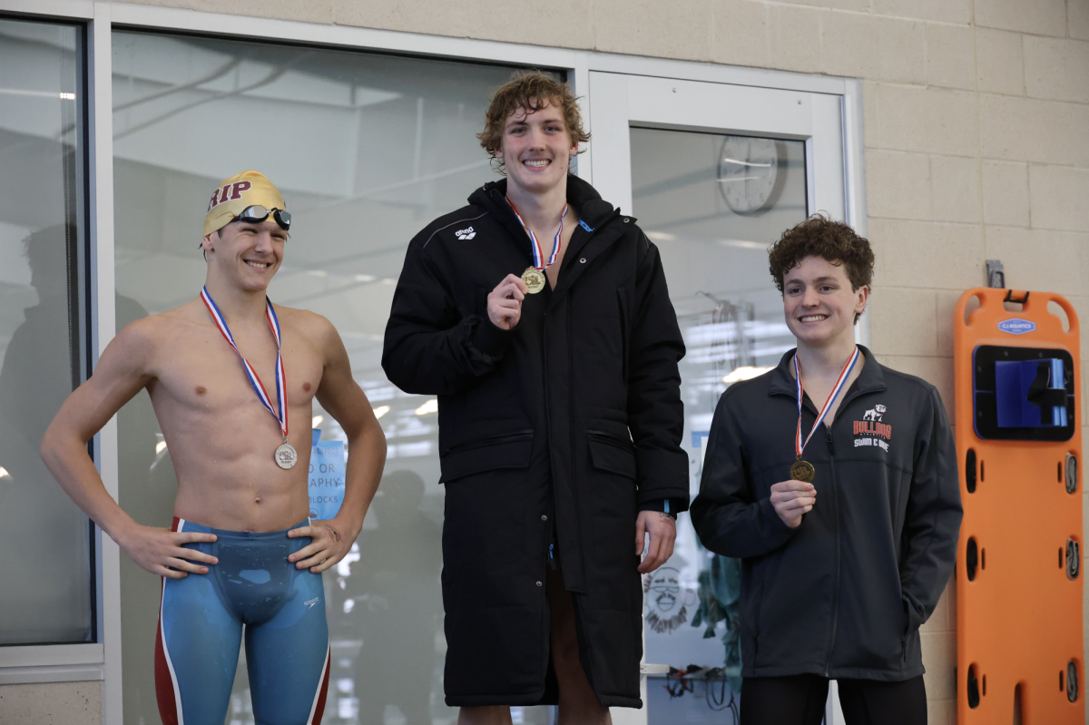 HOLDING UP THE HARDWARE: Cox holds up his gold medal from the district meet. He swept his events winning the 100 meter fly, 100 meter back, and the 200 meter medley relay. 