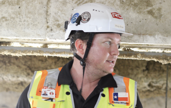 UNDER THE SURFACE: Contractor Philip Shuler sheds light on the new cold water pipes being installed underneath F and E Halls of the Academic Building. This will allow for more enhanced cooling of the building's classrooms.