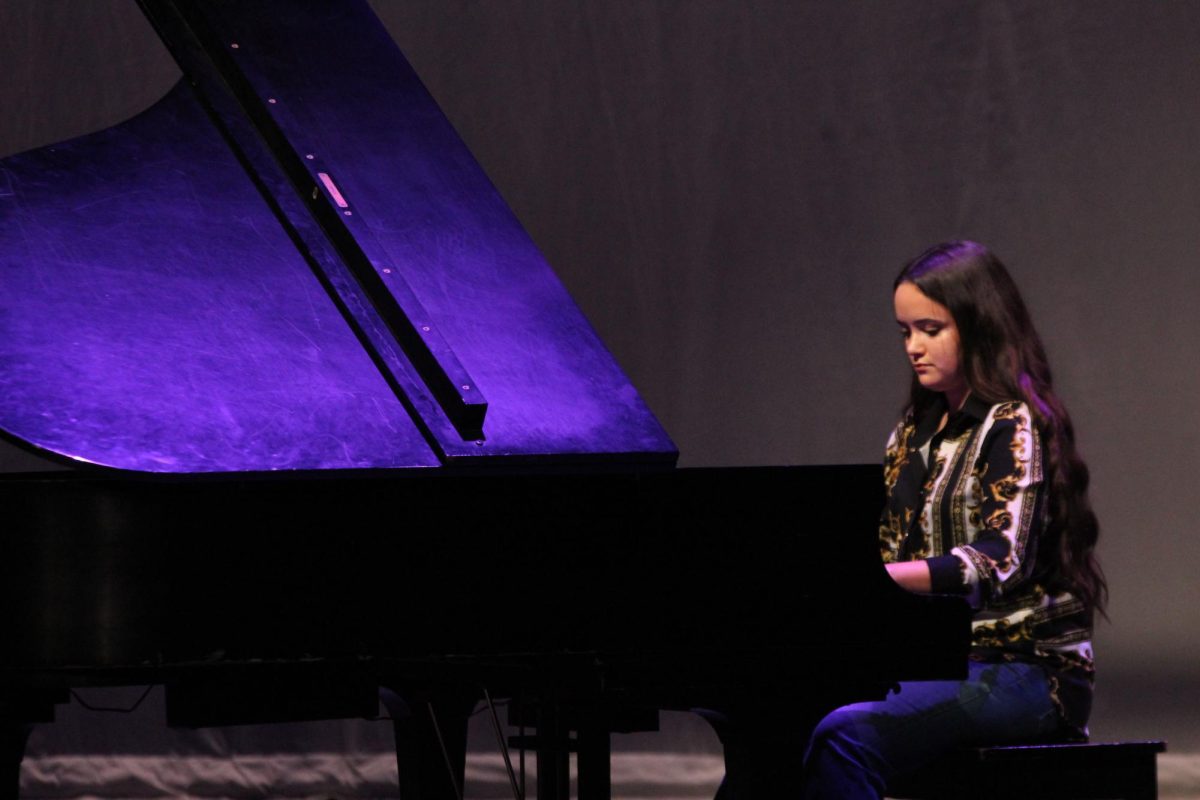 ALL KEYED UP: Second one to perform, senior Besa Carney focuses closely as she plays a Gershwin piano piece. Carney performed her own solo, but she also participated in the Jazz Combo with other students. “I wanted to have a performance of the jazz combo piece before we went to the competition,” Carney said. “I started to play piano when I was four years old, and then I’ve been in a jazz band for all of high school.”