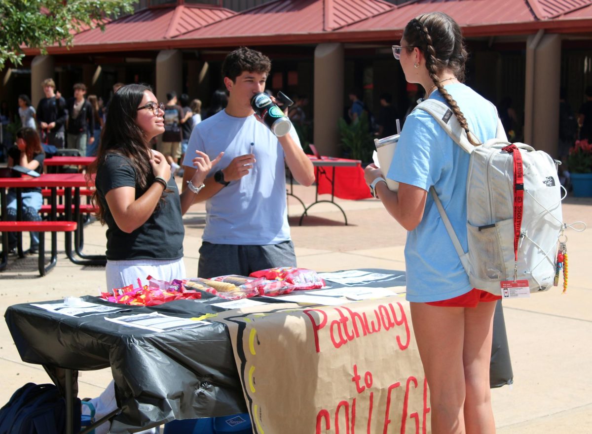 PREP FOR SUCCESS: Juniors Andrea Garcia and Alexander Pena managed the Pathway to College club booth. Pathway to college clubs goal is to help students prepare for college and answer any questions students have about college. “A lot of sophomores come to look into what they could do for their class and what they could do for their future,” Garcia said. “I love being a part of The Pathway to College club because of the impact I can have on people by just answering questions about their futures.” 