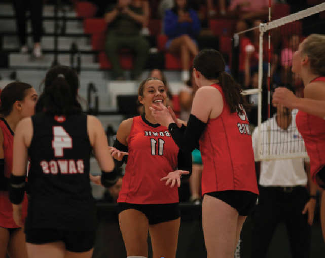 CELEBRATING THE W: Senior Clara Morgan celebrates with her team after scoring yet another point for the womens volleyball team. The Lady ‘Dawgs are striving for a successful playoff run.