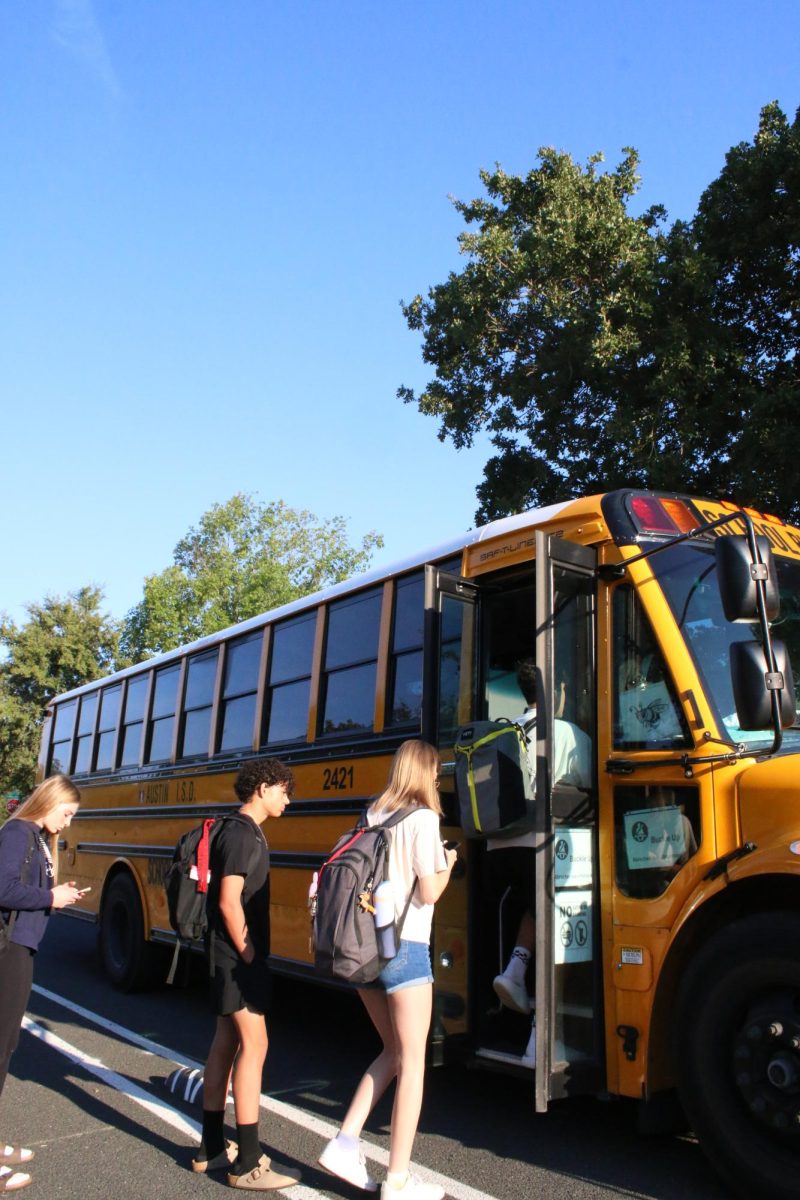 ALL ABOARD: Due to bus issues as of recent, students are seen boarding the bus to school upwards of 10 minutes late. Students are hoping they will be granted a spot as overcrowding has led people to be stranded. 