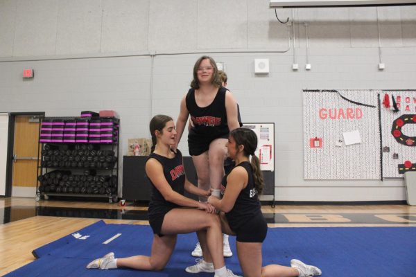 FLYING HIGH: Ruby steps bravely into a stunt based by fellow cheerleaders who cheer her on as she flies. Ruby was born with Down syndrome, but she is pushing past the stereotypes about individuals with disabilities.