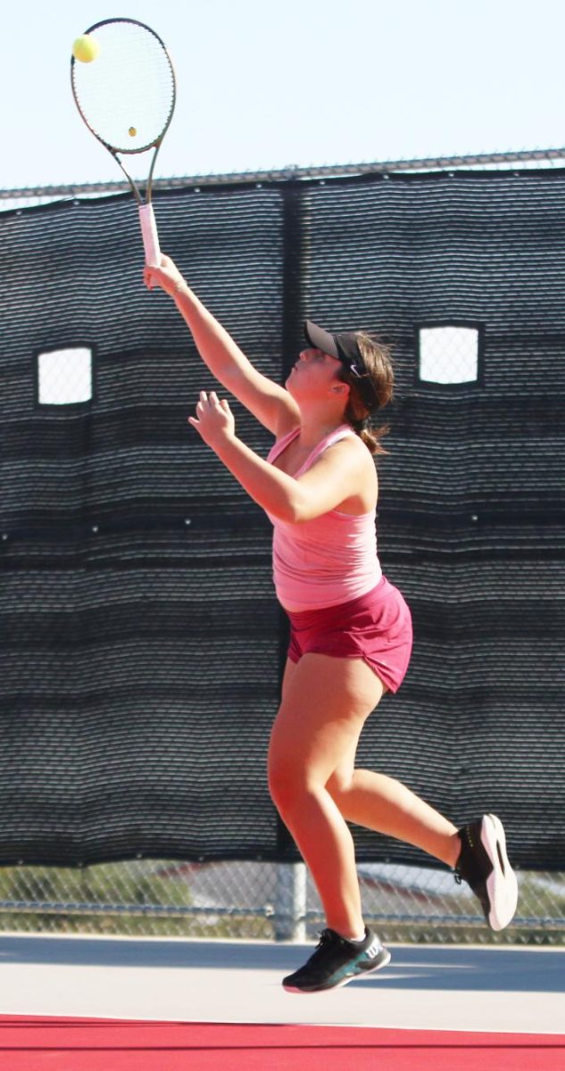 POWER SERVE: Junior captain Tatiana Bosada launches he ball into play with focus. Sharpening her skill during practice, her powerful serve sets the tone for the upcoming season.