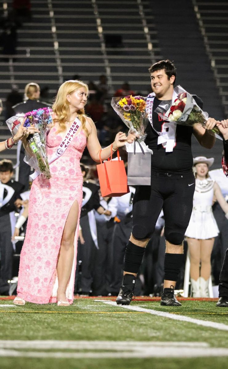 CROWNED IN SCHOOL SPIRIT: Seniors Soren Shelton and Jackson Lang smile at each other after being crowned Homecoming King and Queen. The two decided to run for Homecoming Court together to make the most of their senior year and take part in one of Bowie’s biggest traditions. “Being crowned with Soren was such a cool experience,” Lang said. “It felt really special to share that moment with her, especially since we’ve both been part of so many school events over the years. It’s definitely something I’ll remember as one of the best parts of senior year.” 