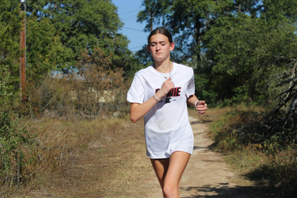 RUNNING IN STRIDE: Freshman Lilly Knauss sprints during her hard working practice. Knauss works out almost every day to keep imrproving her running.