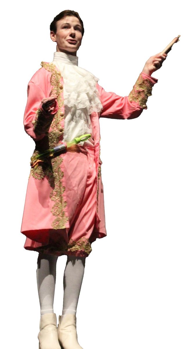 PERIOD PINK: Junior Preston Withrow performing as Prime Minister in TYA shows. Withrow had lots of fun with the colorful, period costumes. 