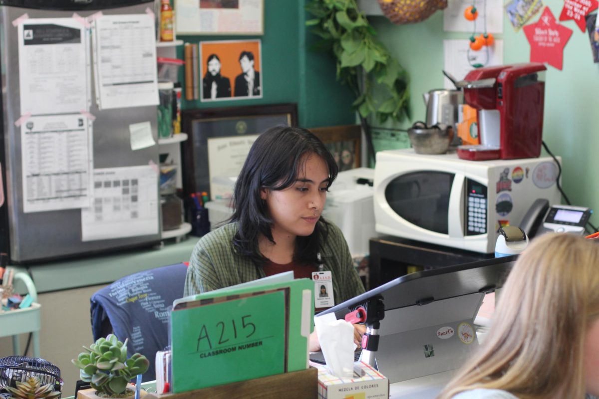 SUBBING STRATEGIES: Substitute teacher Stefania Garcia sits at Jacqueline Gonzalez's desk, covering her class while Gonzalez was out. Garcia subbed for Gonzalez's freshman and senior English classes. 