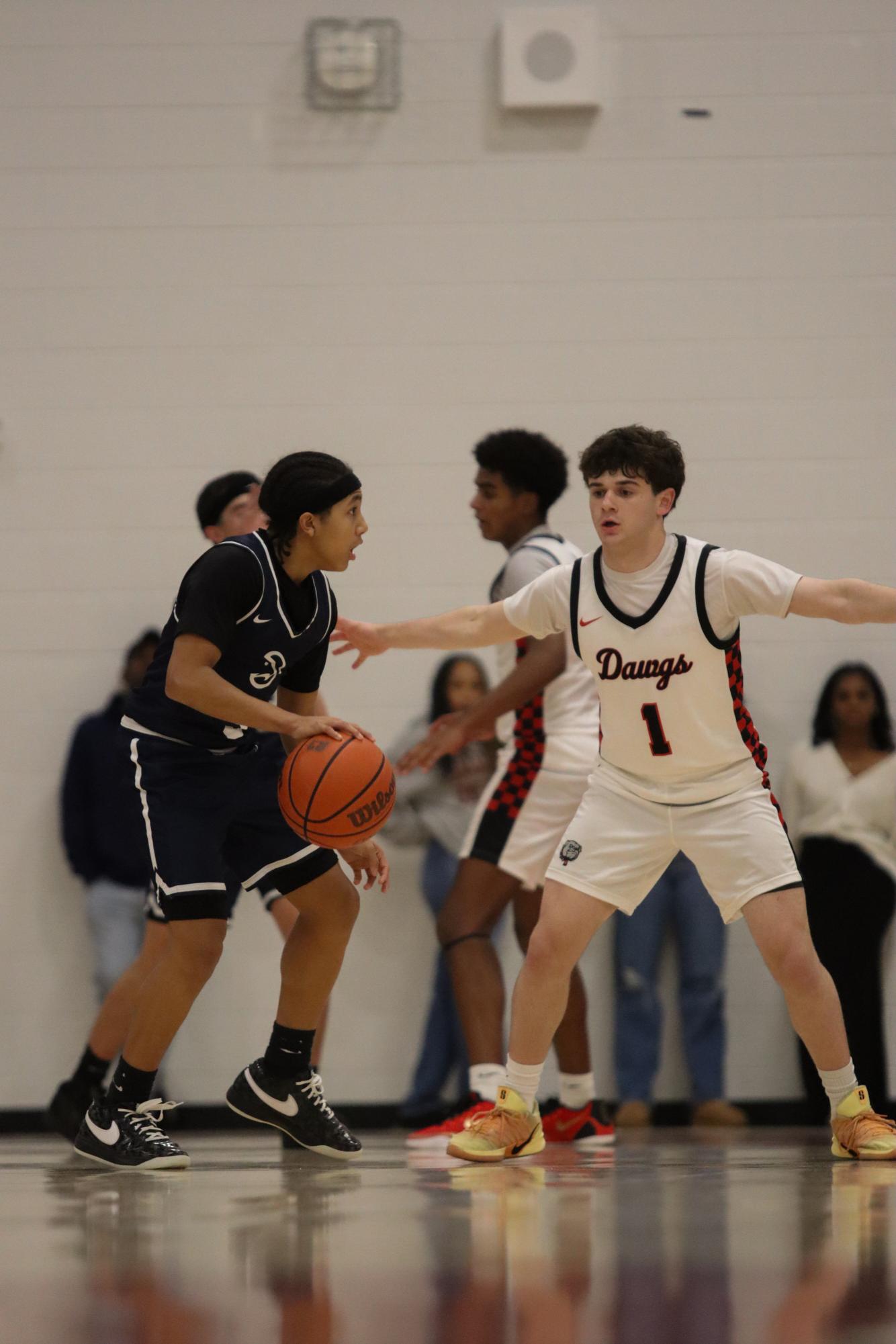 DEFENSE UP: As the opponent is about to pass to his teammate, Junior Jake Fidlerman is present, ready to block. HIs athletic instincts allows him to predict the next movement, and protect his teams net. 