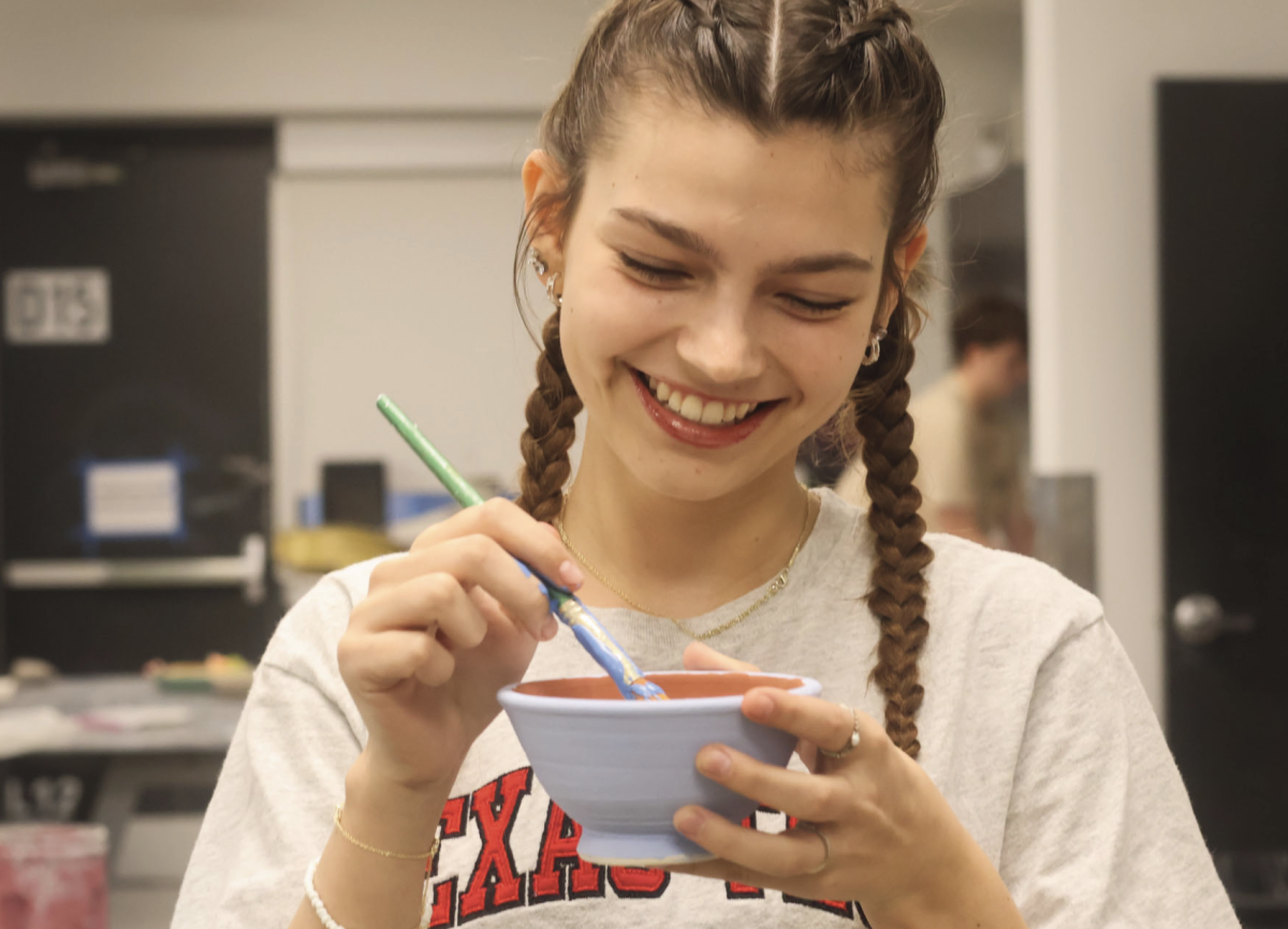 THE FINAL COAT: Junior Tarin Scannell paints a bowl for the Austin Empty Bowls Project, an event run by the Central Texas Food Bank. These bowls are a main attraction for the event, and will help raise money for the Central Texas Food Bank Kids Cafe and Meals on Wheels Central Texas.