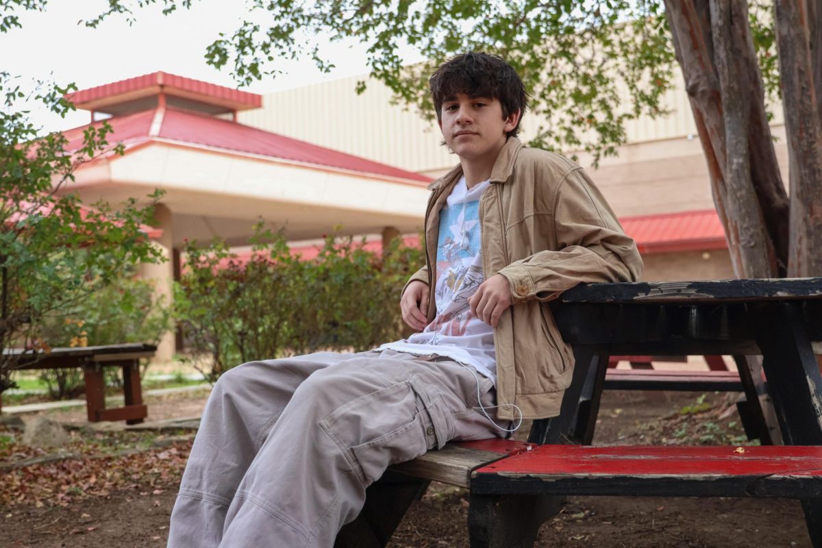 LOOKING STYLISH: Raf Pena sits on the benches out in the courtyard. Pena has been redesigning clothes for years. 
