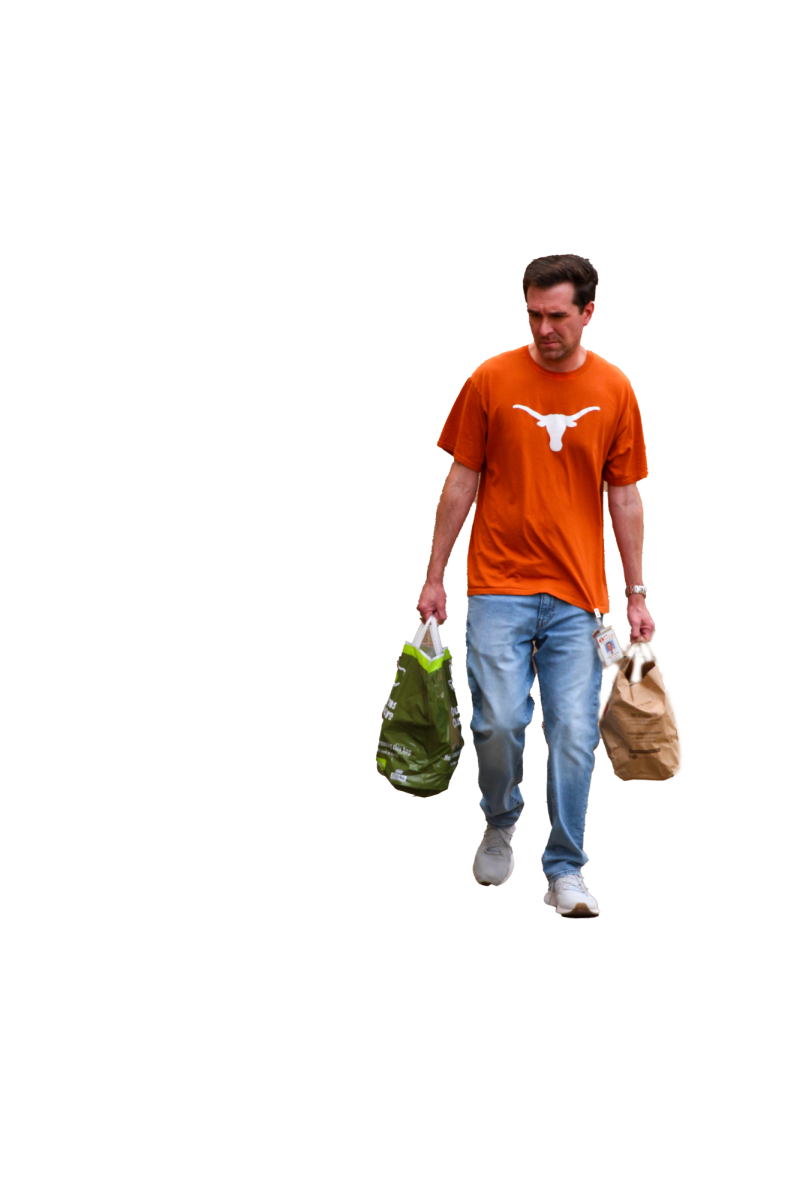 SUPER SOUP: Student Council advisor Alejandro Garcia carries bags of cans. A total of 5,305 pounds of cans were donated by students and staff, setting a Bowie record.