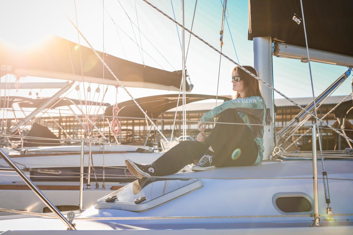 NEW HORIZONS: Sitting on a sailboat at Outbound Sailing, Corbyn Haley gazes out at the setting sun. Haley started sailing with the interest of pursuing the National Coast Guard, following in the footsteps of her Army father.