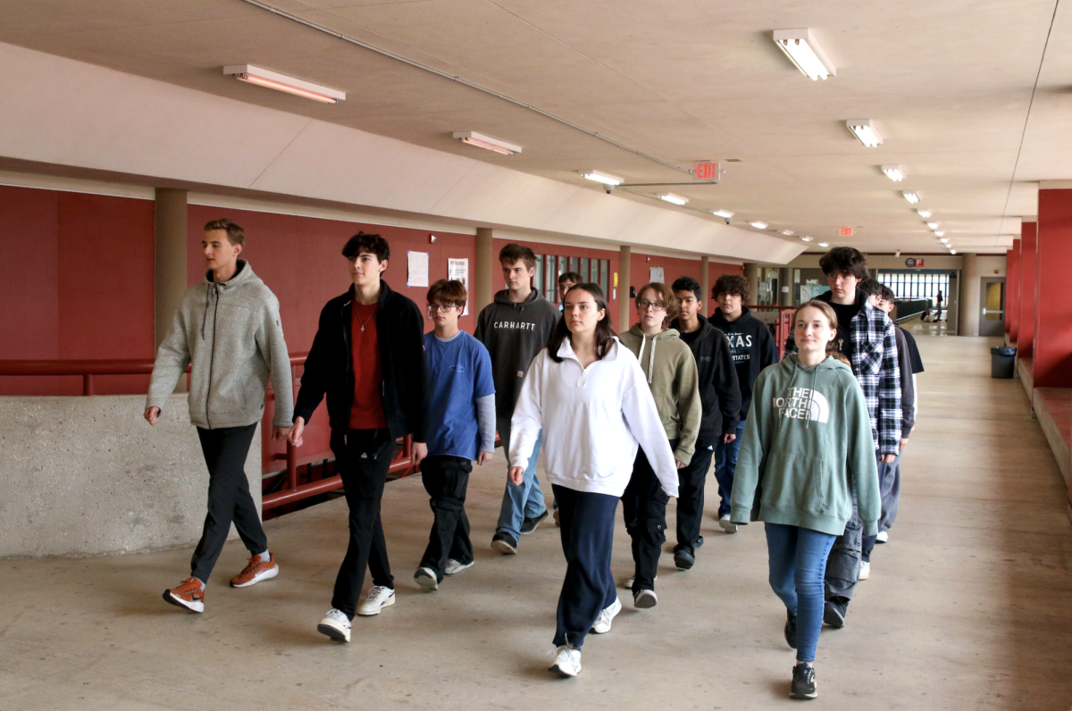 IN UNISON: Marching in formation, junior Eli Printz leads a Bowie JROTC cadet. Printz has been in JROTC for three years, and has now ascended to the position of Cadet formation Major.