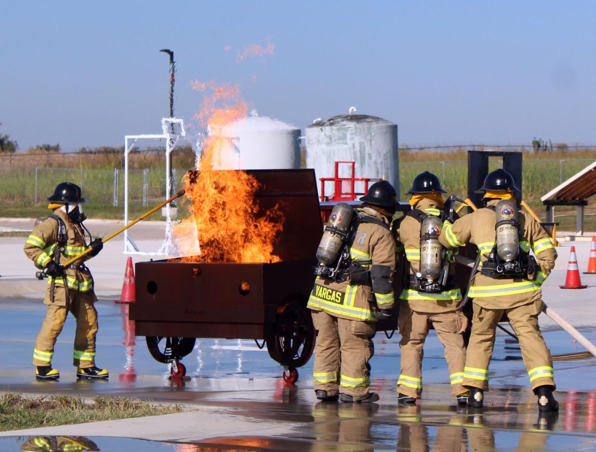 FIGHTING FLAMES: Students at the LBJ Fire Academy stand preparing to put a fire out. Participating in such activities allows them to work towards earning their firefighting certifications.