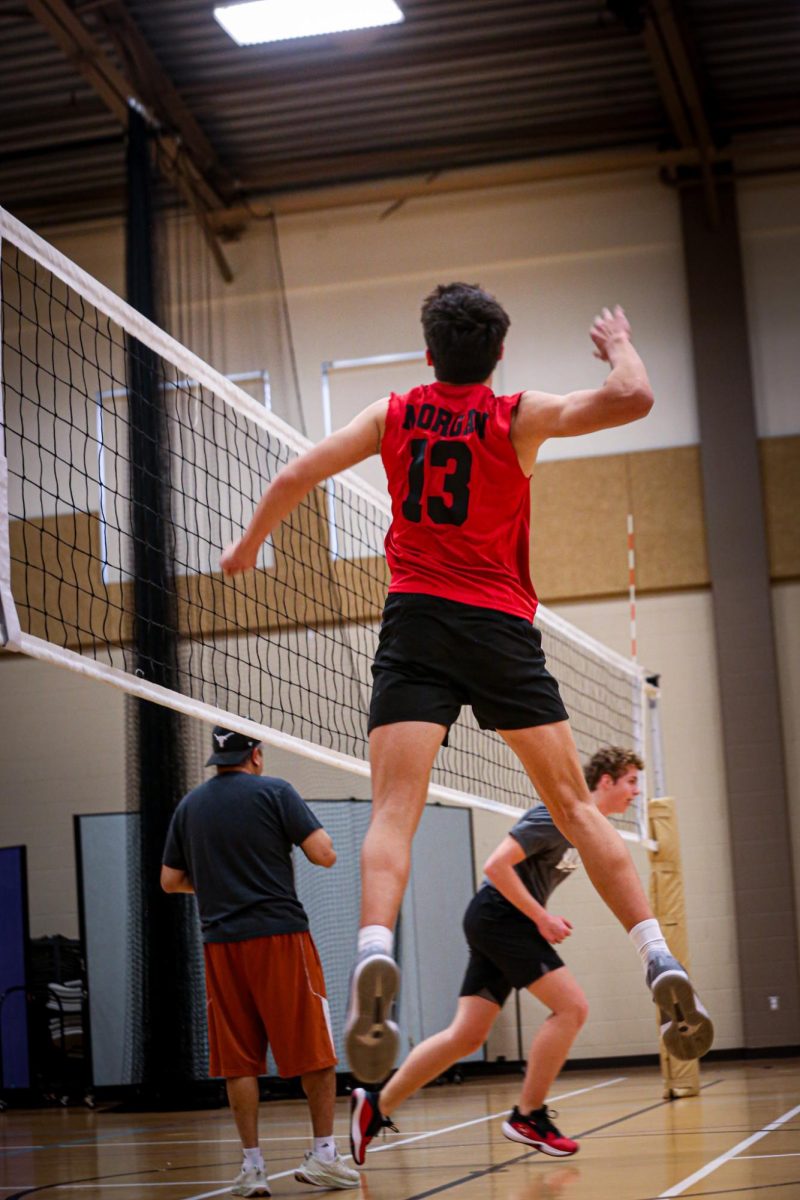 SPIKING IT DOWN: Junior Morgan Whited sticks his hand out to block the ball from making it over the net. The first game of the season is against Westwood on February 19.  “We have a lot of young people on the team, like freshmen and sophomores,” Whited said. “We have a pretty good team, though there’s definitely a lot of room for growth. It’s better than last year.” 