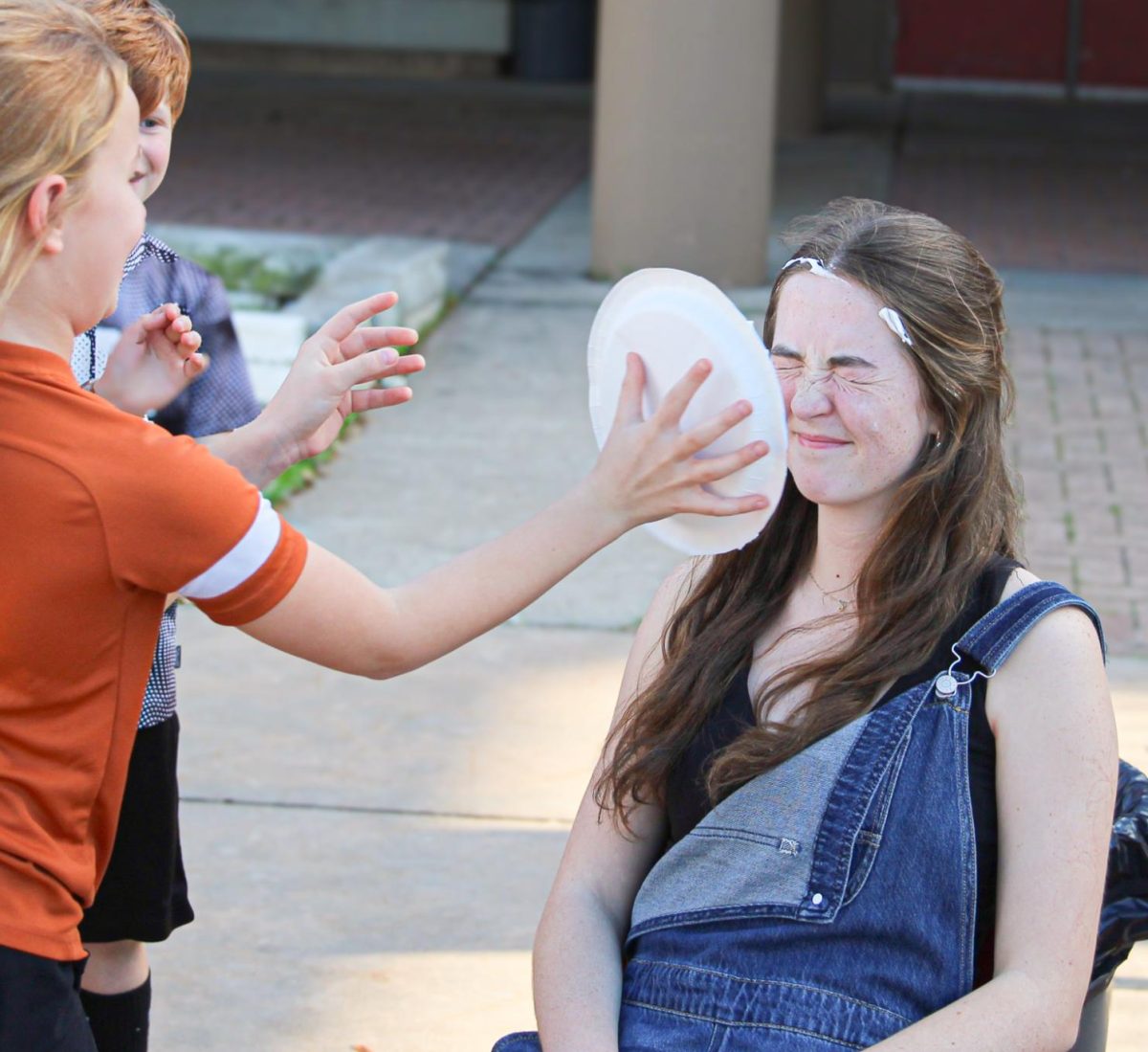 IN YOUR FACE: Wednesday March 11, members of Bowie’s Ready Set Teach program set up a booth in which kids could play games and upon winning, would pie somebody of their choice in the face. The game consisted of throwing hula hoops around traffic cones trying to make three of your four shots. “Getting pied in the face definitely sucked,” junior Ready Set Teach member Emerson Strong said. “ But it was all worth it in the end knowing we helped to make a core memory for those kids, even if it hurt.” 