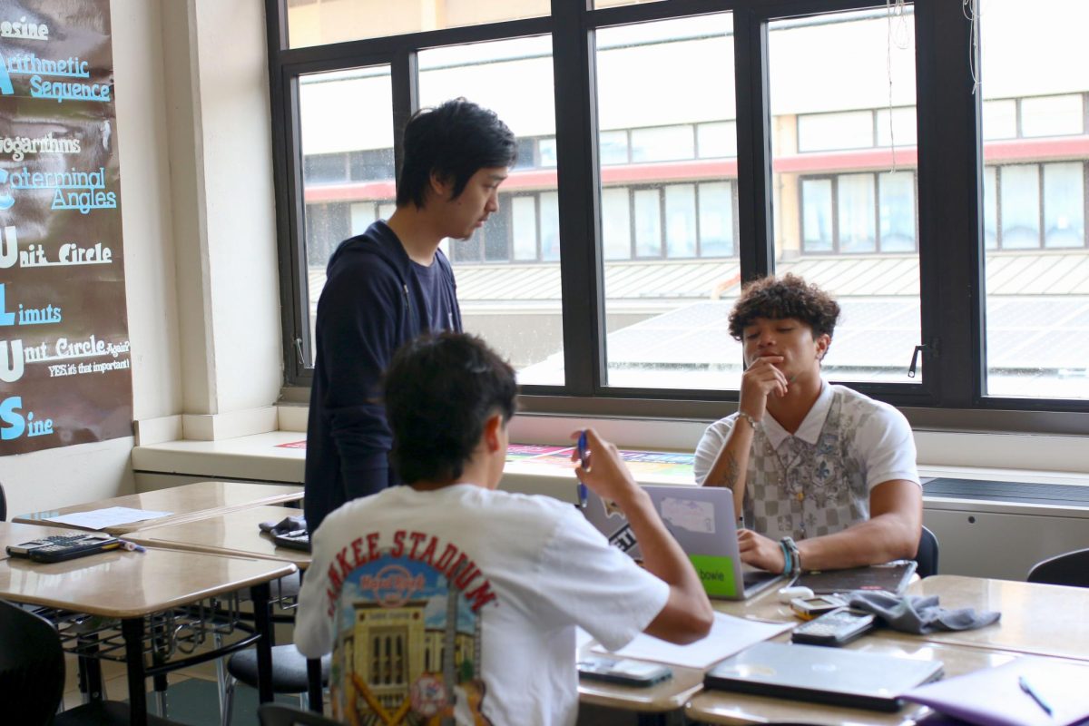 LOSS FELT: Students gather around to continue their studies following their teachers recent passing. The school is making sure his students are staying on track with their academics.