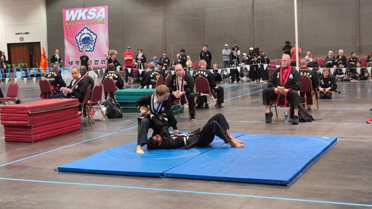 PINNED DOWN: Senior Penelope Durbin secures a win by holding her opponent down on the mat. She won first place at the World Tournament in 2024 and keeps on proving her skills in more recent competitions.
