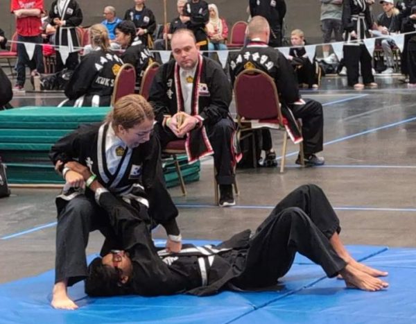 PINNED DOWN: Senior Penelope Durbin secures a win by holding her opponent down on the mat. She won first place at the World Tournament in 2024 and keeps on proving her skills in more recent competitions.