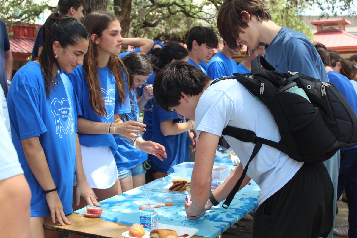 BLUE RETURNS: PALS students hand out cookies to students wearing blue during the Blue Out Bowie event. After not being held for several years, the tradition returned this year to raise awareness for Child Abuse Awareness Month. 
