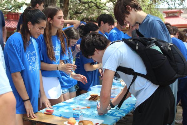BLUE RETURNS: PALS students hand out cookies to students wearing blue during the Blue Out Bowie event. After not being held for several years, the tradition returned this year to raise awareness for Child Abuse Awareness Month.