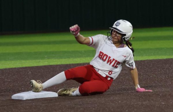 SLIPPING AND SLIDING: Junior Cecilia Alvarez slides to safety, helping her team load the bases and secure more runs against their opponents, the Buda Johnson Jaguars. In total, the Lady Dawgs were able to push four runs across the plate, but fell just a short of winning the game in extra innings.